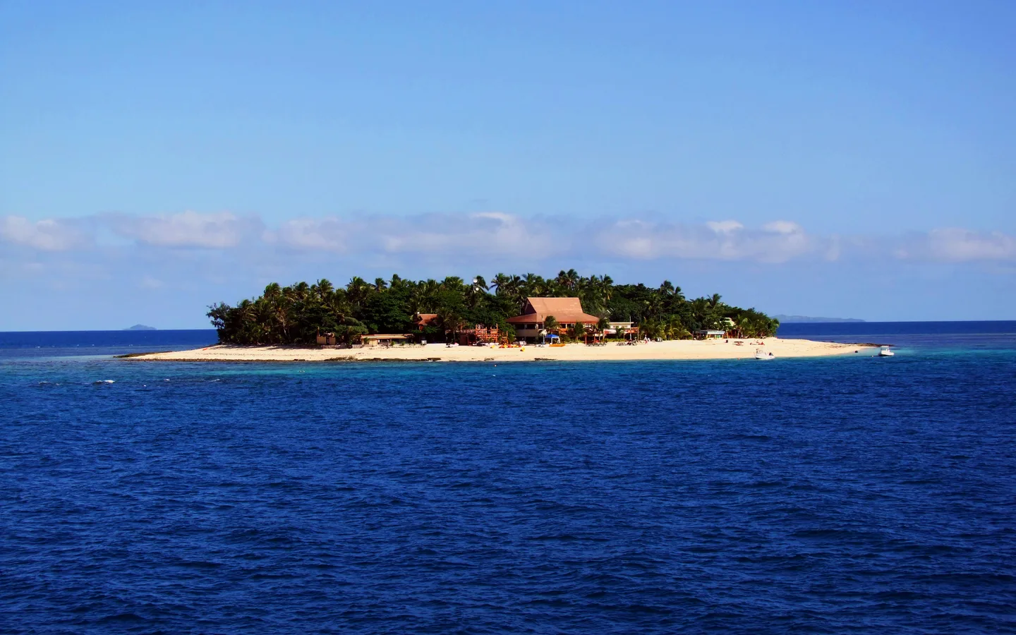 A small island in Fiji’s Mamanuca group surrounded by blue water