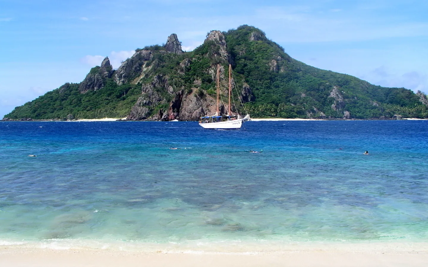 Monu Island and a sailing boat in Fiji’s Mamanuca group